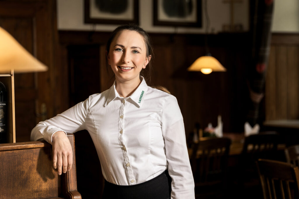 Maria Laupheimer in der Gaststube im Brauereigasthof-Hotel Laupheimer bei einem Fotoshooting trägt sie eine weiße Bluse